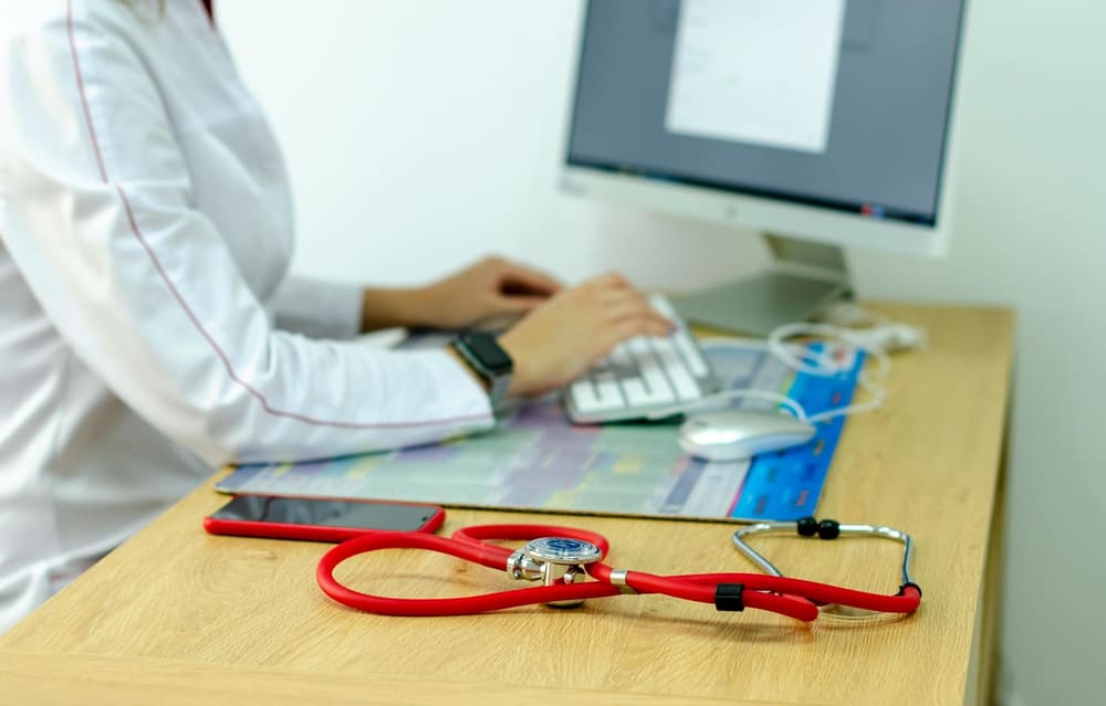 Dietitian reviewing notes at a desk